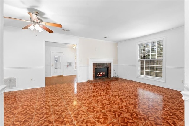 unfurnished living room featuring a brick fireplace, ceiling fan, and visible vents