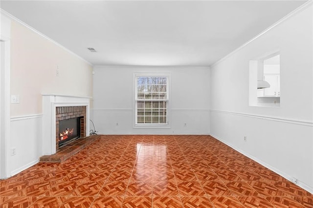 unfurnished living room featuring crown molding, a fireplace, and baseboards