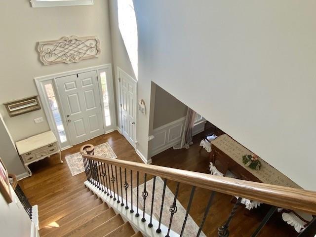 dining area with crown molding, dark wood-type flooring, and a raised ceiling