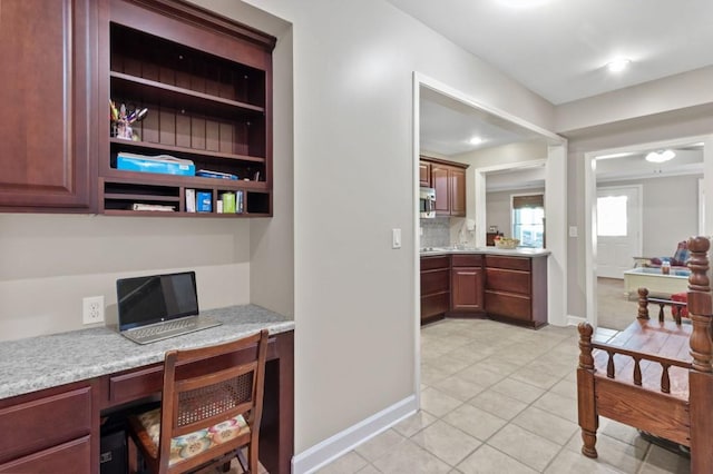 tiled office space featuring built in desk