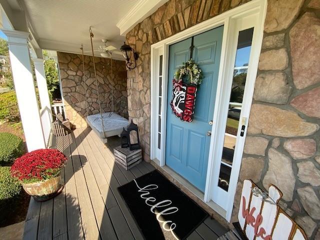 view of exterior entry with a porch