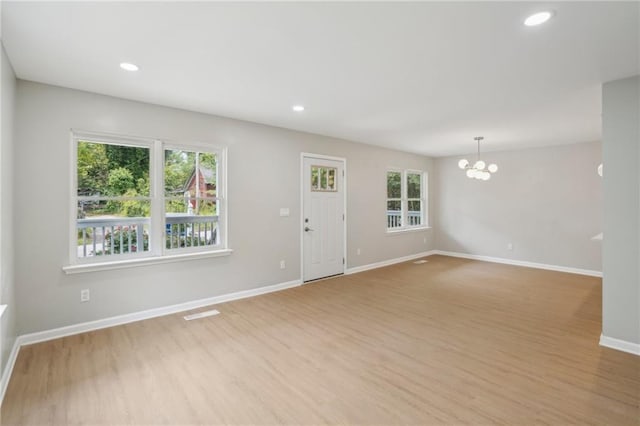 789 Third St, Stone Mountain, GA 30083 - unfurnished living room with a chandelier, light wood finished floors, baseboards, and recessed lighting