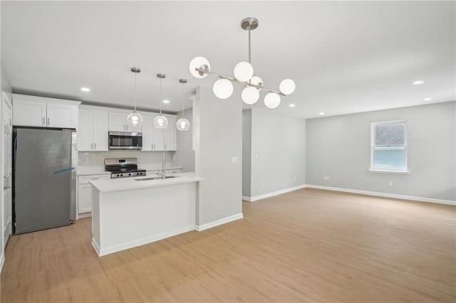 789 Third St, Stone Mountain, GA 30083 - kitchen with stainless steel appliances, light wood-style floors, white cabinetry, recessed lighting, and light countertops