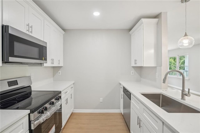 789 Third St, Stone Mountain, GA 30083 - kitchen featuring appliances with stainless steel finishes, a sink, light wood-style floors, white cabinets, and recessed lighting
