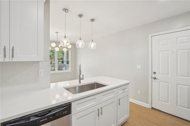789 Third St, Stone Mountain, GA 30083 - kitchen with a sink, stainless steel dishwasher, light wood-type flooring, white cabinets, and light countertops