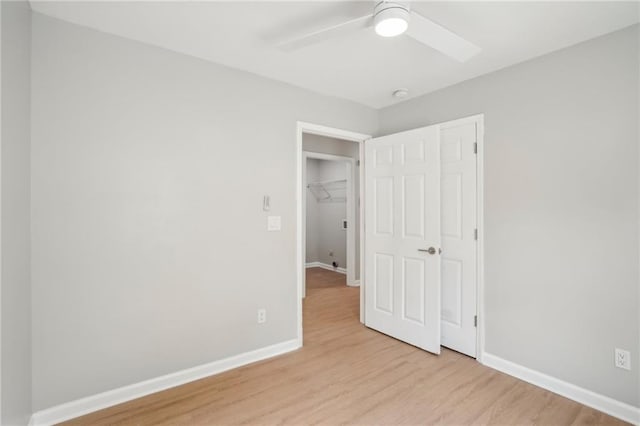 789 Third St, Stone Mountain, GA 30083 - unfurnished bedroom featuring light wood finished floors, baseboards, and a ceiling fan