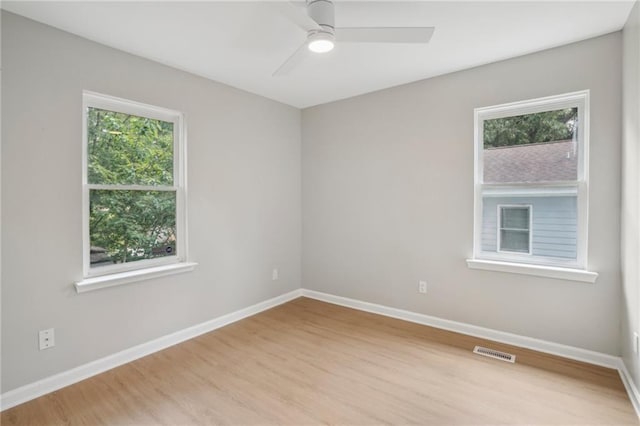 789 Third St, Stone Mountain, GA 30083 - empty room with wood finished floors, healthy amount of natural light, ceiling fan, and baseboards