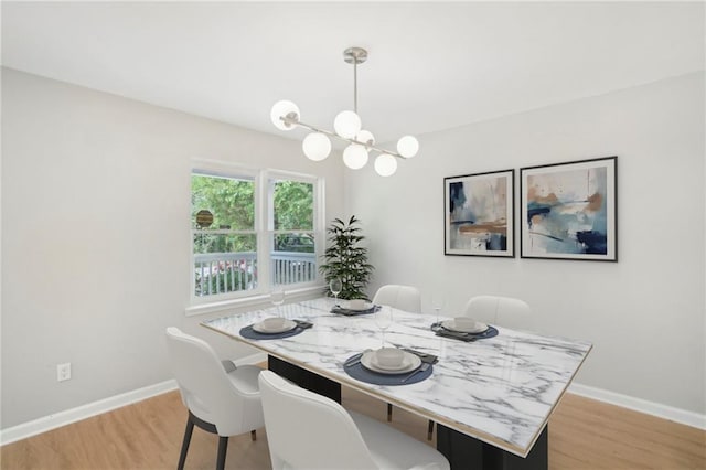 789 Third St, Stone Mountain, GA 30083 - dining area featuring a chandelier, light wood-type flooring, and baseboards