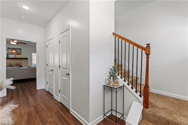 corridor featuring baseboards and stairs