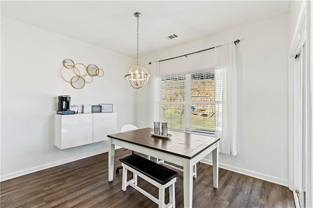 dining area with dark wood-style floors, baseboards, a chandelier, and visible vents