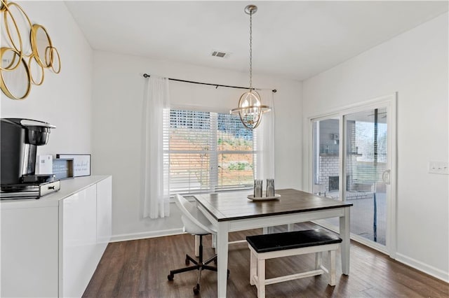 dining space featuring baseboards, dark wood-style flooring, visible vents, and a chandelier