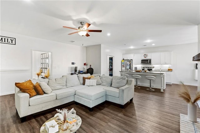 living room featuring a ceiling fan, baseboards, visible vents, recessed lighting, and dark wood-style flooring