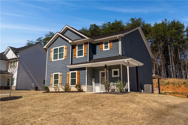 craftsman inspired home with central air condition unit, a porch, and a front yard