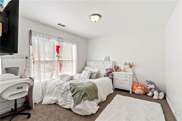 bedroom featuring baseboards, visible vents, and carpet