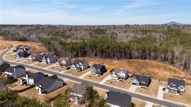 aerial view with a residential view and a view of trees