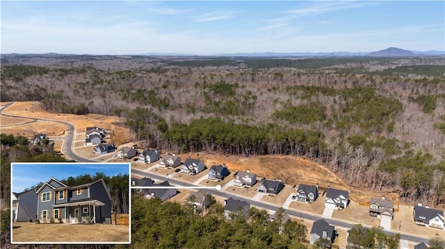 drone / aerial view featuring a residential view, a forest view, and a mountain view
