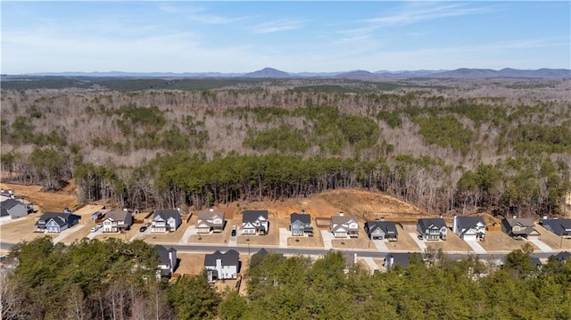 drone / aerial view with a mountain view, a forest view, and a residential view