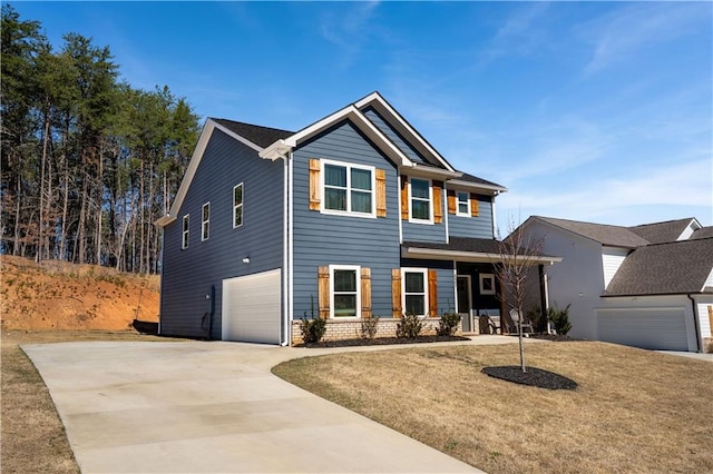 view of front of home with a front lawn, driveway, and an attached garage