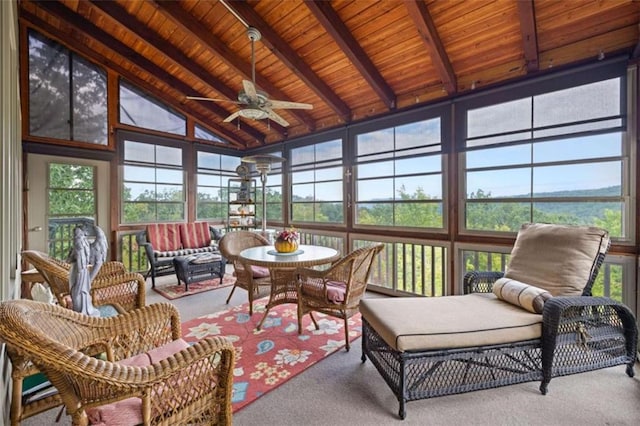 sunroom / solarium featuring outdoor lounge area, beam ceiling, carpet floors, and wood ceiling