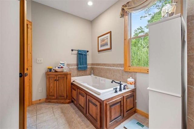 full bathroom featuring tile patterned floors, a garden tub, and recessed lighting