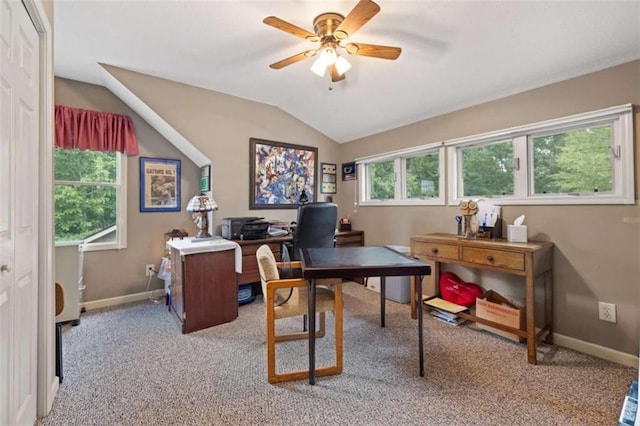 home office with light colored carpet, ceiling fan, vaulted ceiling, and baseboards