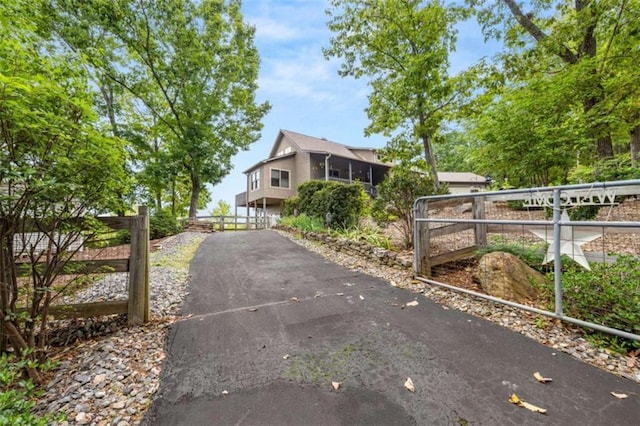 exterior space with fence, a gate, and driveway