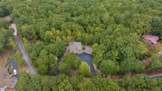 birds eye view of property featuring a wooded view