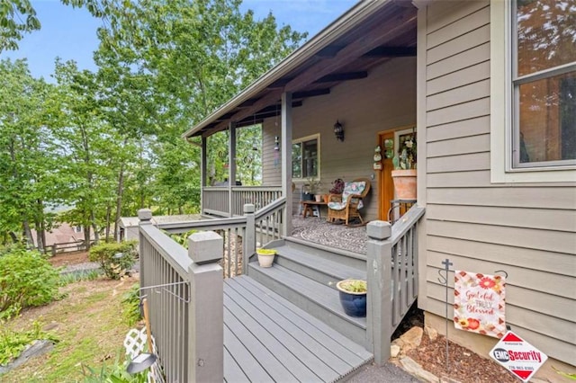 wooden terrace featuring covered porch