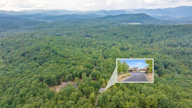 aerial view with a wooded view and a mountain view