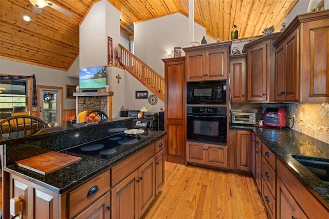 kitchen featuring wood ceiling, black appliances, light wood-type flooring, a stone fireplace, and backsplash