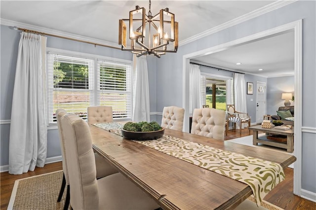 dining area with a wealth of natural light, a chandelier, crown molding, and dark hardwood / wood-style flooring