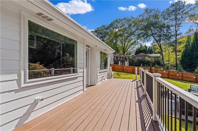 wooden terrace with a yard