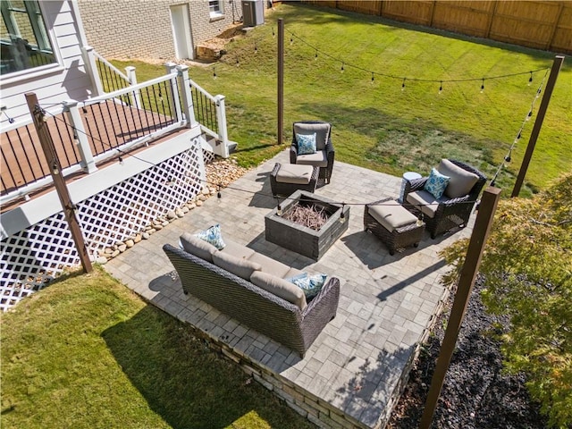 view of yard featuring an outdoor living space with a fire pit and a patio area