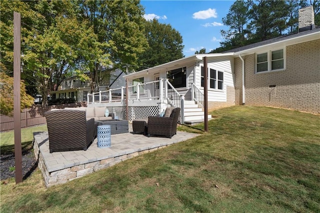 back of property with a deck, a patio, outdoor lounge area, and a yard