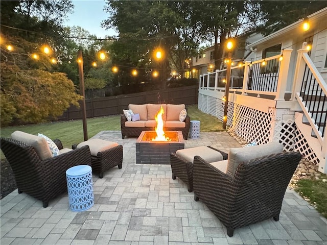 patio terrace at dusk with an outdoor living space with a fire pit