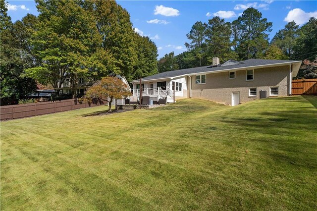 rear view of house with a yard