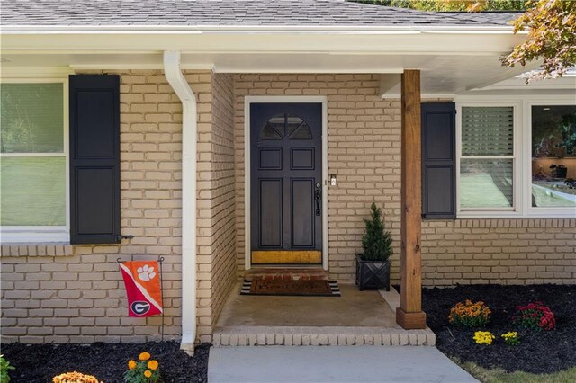 view of exterior entry with covered porch