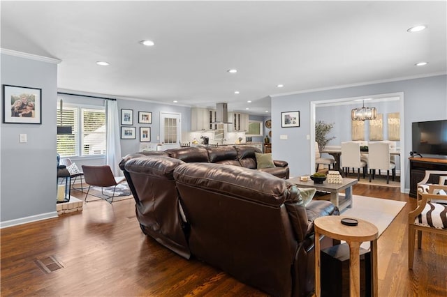 living room with a chandelier, crown molding, and dark hardwood / wood-style flooring