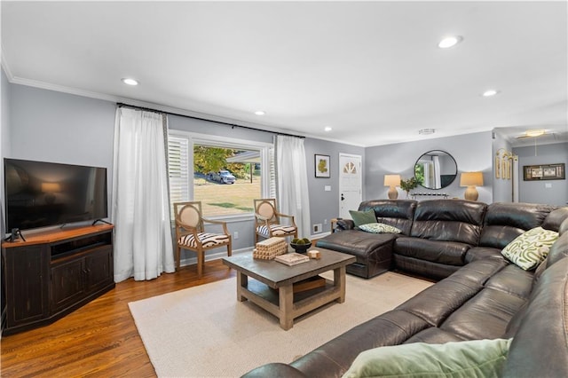 living room featuring light wood-type flooring and ornamental molding