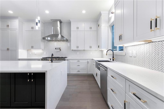 kitchen with white cabinets, light countertops, and wall chimney range hood