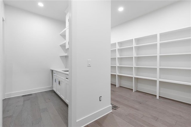 interior space with visible vents and wood finished floors