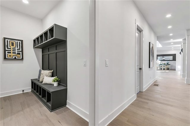 mudroom with light wood-style floors, recessed lighting, and baseboards