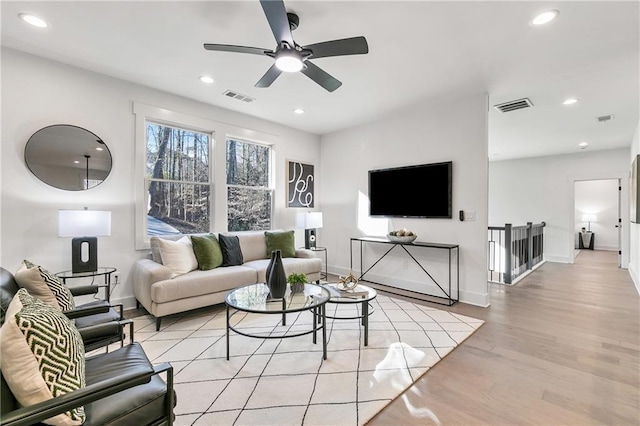 living room with light wood-type flooring, recessed lighting, and visible vents