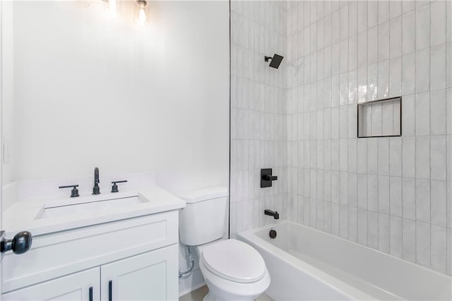 bathroom with tub / shower combination, vanity, and toilet