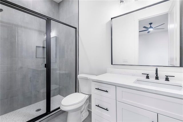 full bathroom with toilet, a shower stall, a ceiling fan, and vanity