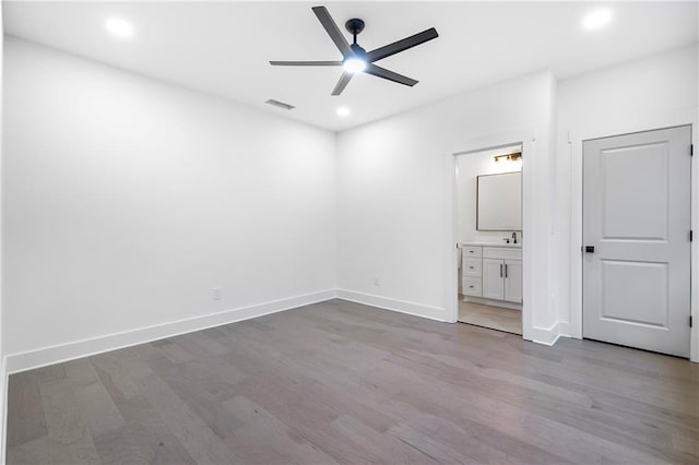 unfurnished bedroom with recessed lighting, wood finished floors, visible vents, and baseboards