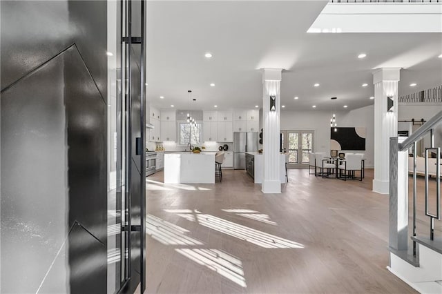 entryway featuring decorative columns, stairway, french doors, and recessed lighting