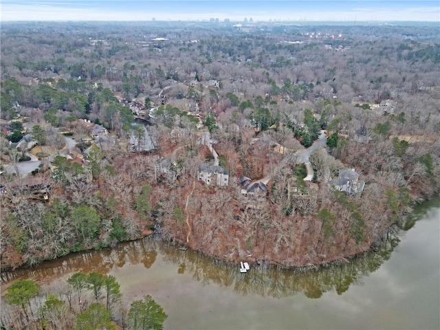 drone / aerial view featuring a water view and a wooded view