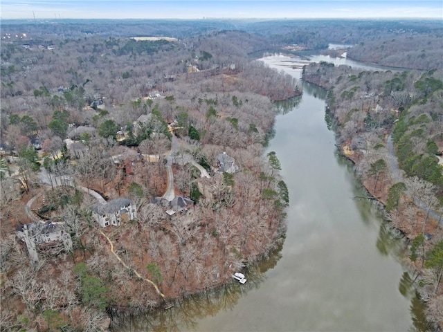 drone / aerial view featuring a water view and a forest view