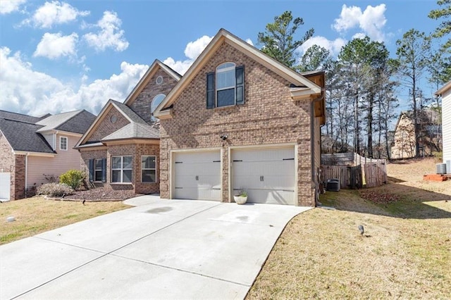 traditional-style home with driveway, a garage, a front lawn, and brick siding